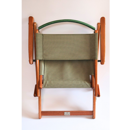 Folded chair in green material and wood frame