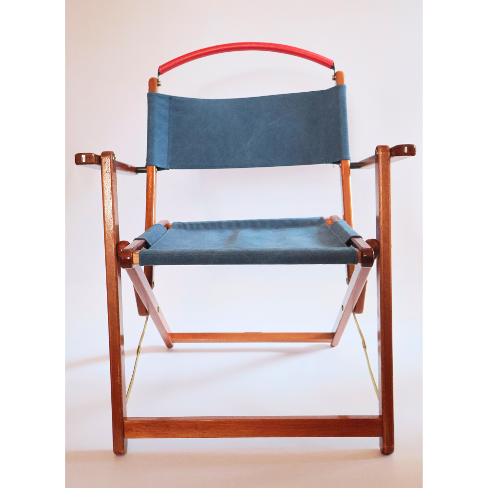 Wooden chair with blue canvas seat and backrest on a white background