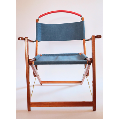Wooden chair with blue canvas seat and backrest on a white background