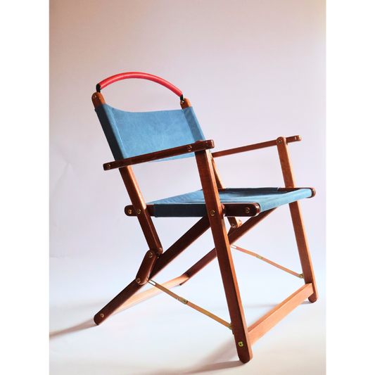 Foldable chair with blue seat and red backrest on a white background