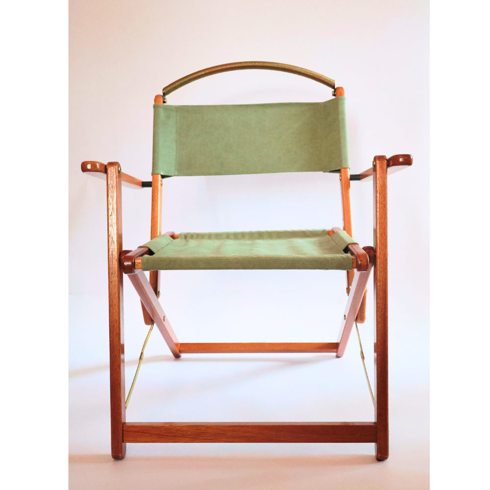 Director's chair with green fabric seat and backrest on a white background