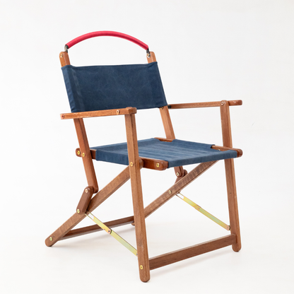 Foldable chair with wooden frame and blue seat and backrest on a white background